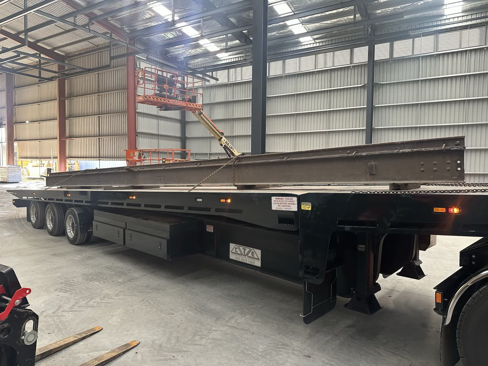 All Tow Melbourne flatbed trailer loaded with steel beam for building supplies transport