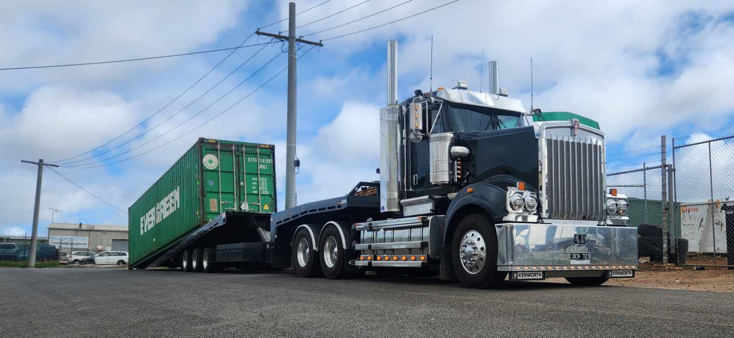 Kenworth heavy tilt tray towing shipping container in Bacchus Marsh