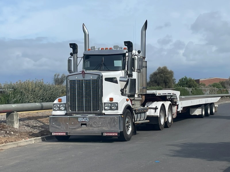 Kenworth heavy tilt tray towing portable building in Gisborne