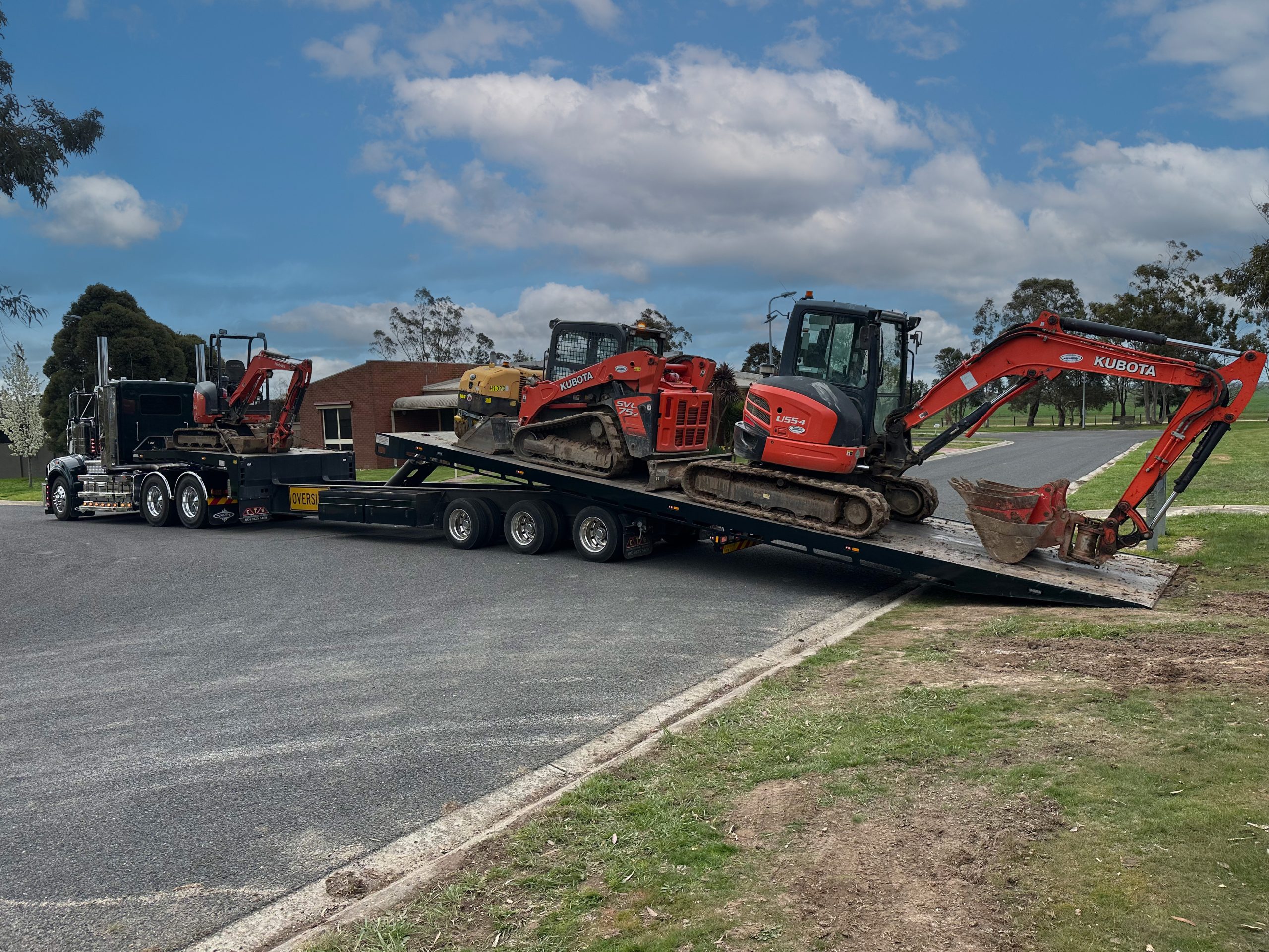 Heavy tilt tray truck loading excavators for machinery towing in Melton